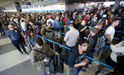 Passengers at O'Hare International Airport wait in line to be screened at a TSA checkpoint on May 16, 2016.