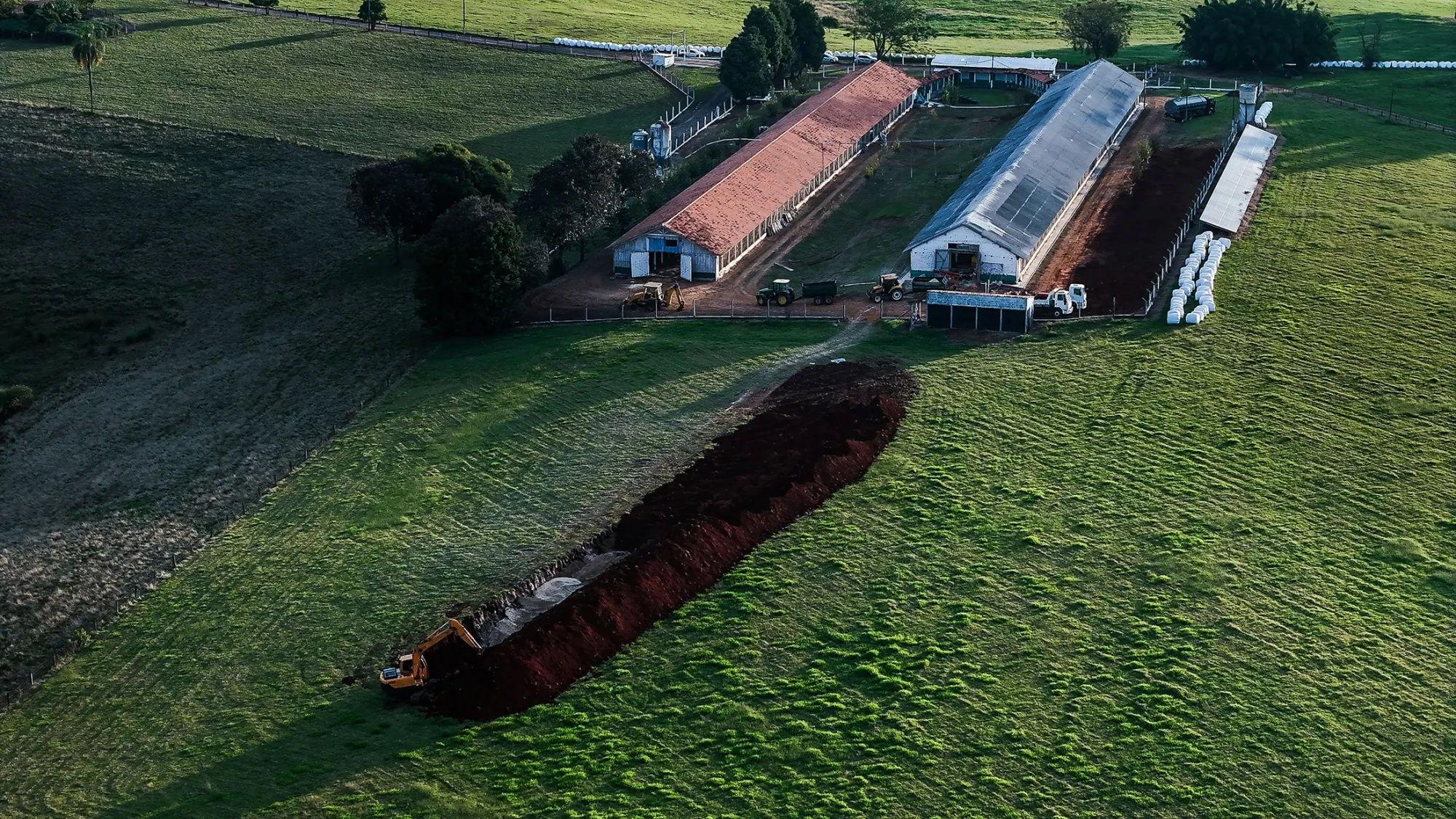 An excavator digs a trench to bury infected poultry on a commercial farm where a bird flu outbreak was detected last week, in the municipality of Montenegro, Rio Grande do Sul state, Brazil.