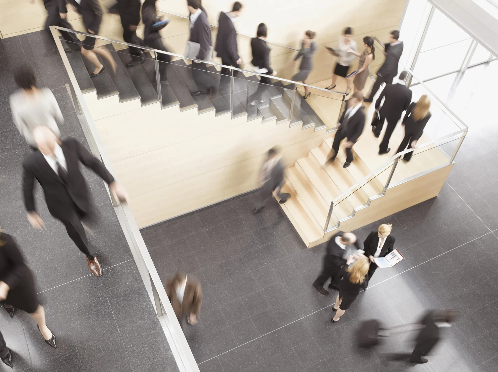 Businesspeople walking in busy office building