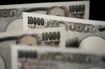 Japanese 10,000 yen banknotes are arranged for a photograph in Tokyo, Japan.