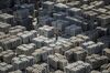 A worker stands on bundles of aluminum ingots at a China National Materials Storage and Transportation Corp. stockyard in Wuxi, China, on Thursday, Aug. 23, 2018. The U.S. and China imposed fresh tariffs on each other's goods in the middle of trade talks aimed at averting the worsening conflict between the world's two biggest economies.