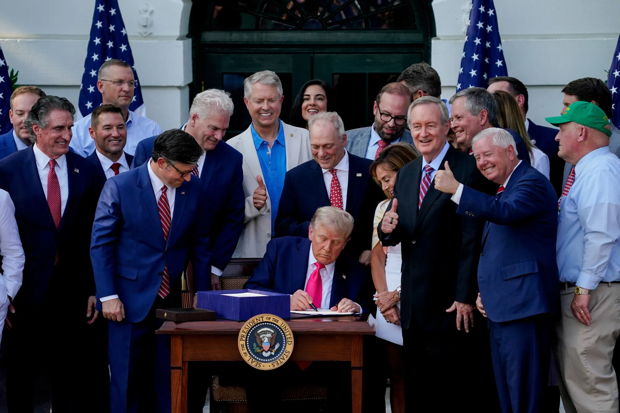 US President Donald Trump signs the One Big Beautiful Bill Act on the South Lawn of the White House in Washington on July 4.