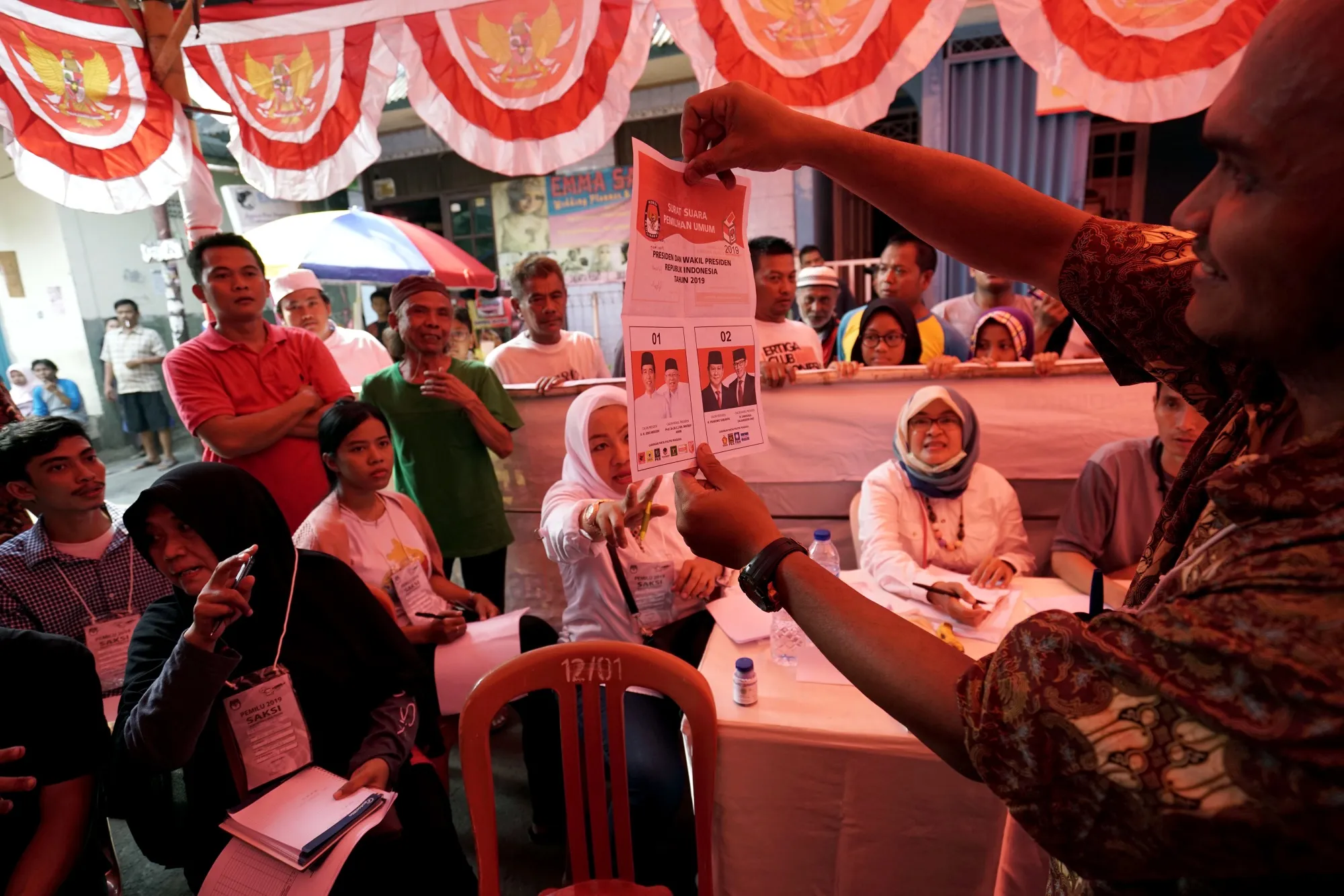 An election official holds a ballot during the counting for the general elections at a polling station in Jakarta, April 17.