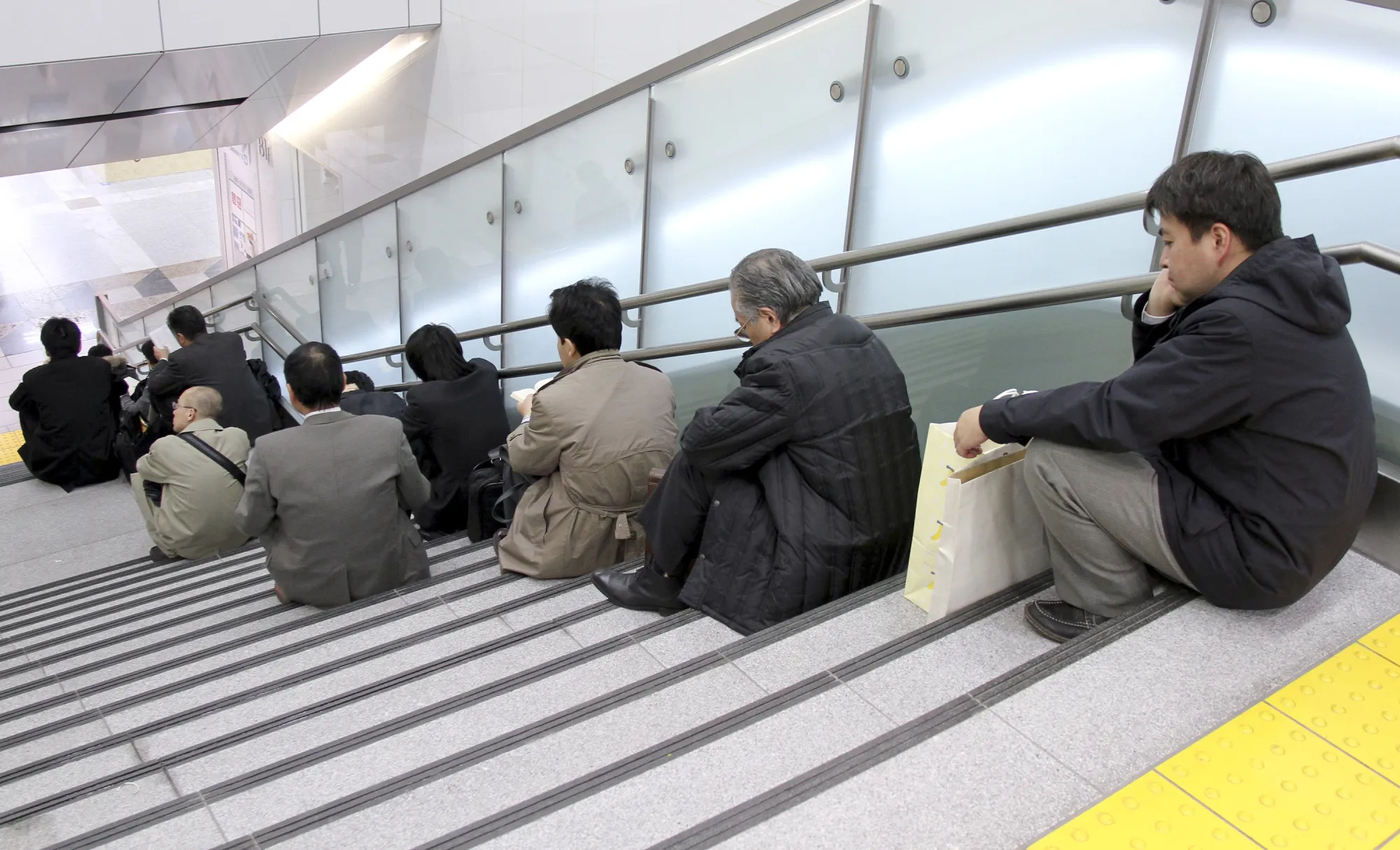 People wait at the Tokyo station following an earthquake on March 12, 2011.
