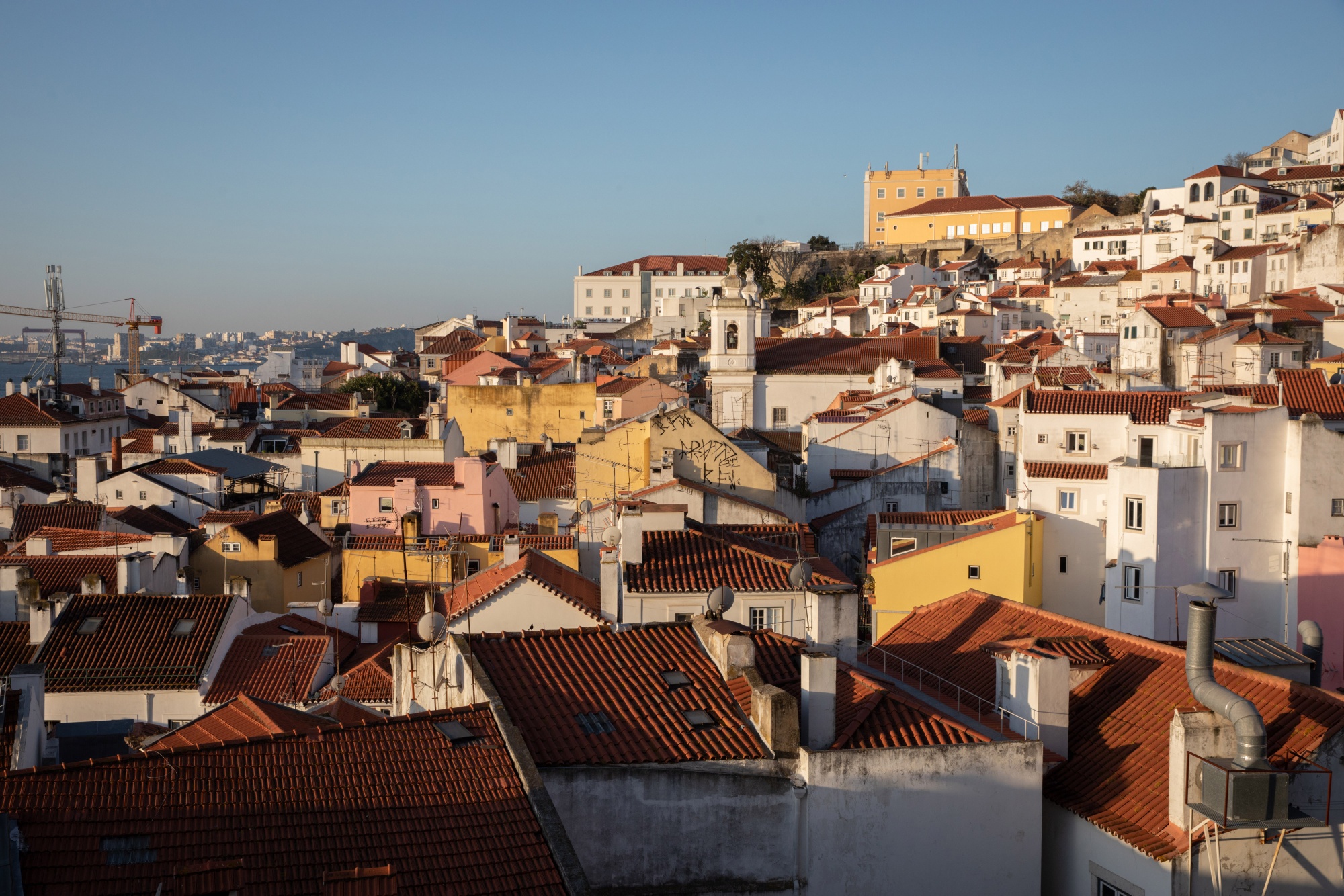 Residential buildings on the skyline in the Alfama district of Lisbon, Portugal, on Thursday, Feb. 16, 2023. Portugal will end its so-called golden visa program for new foreign property buyers as it tries to address the lack of affordable housing in one of Western Europe’s poorest economies. Photographer: Goncalo Fonseca/Bloomberg