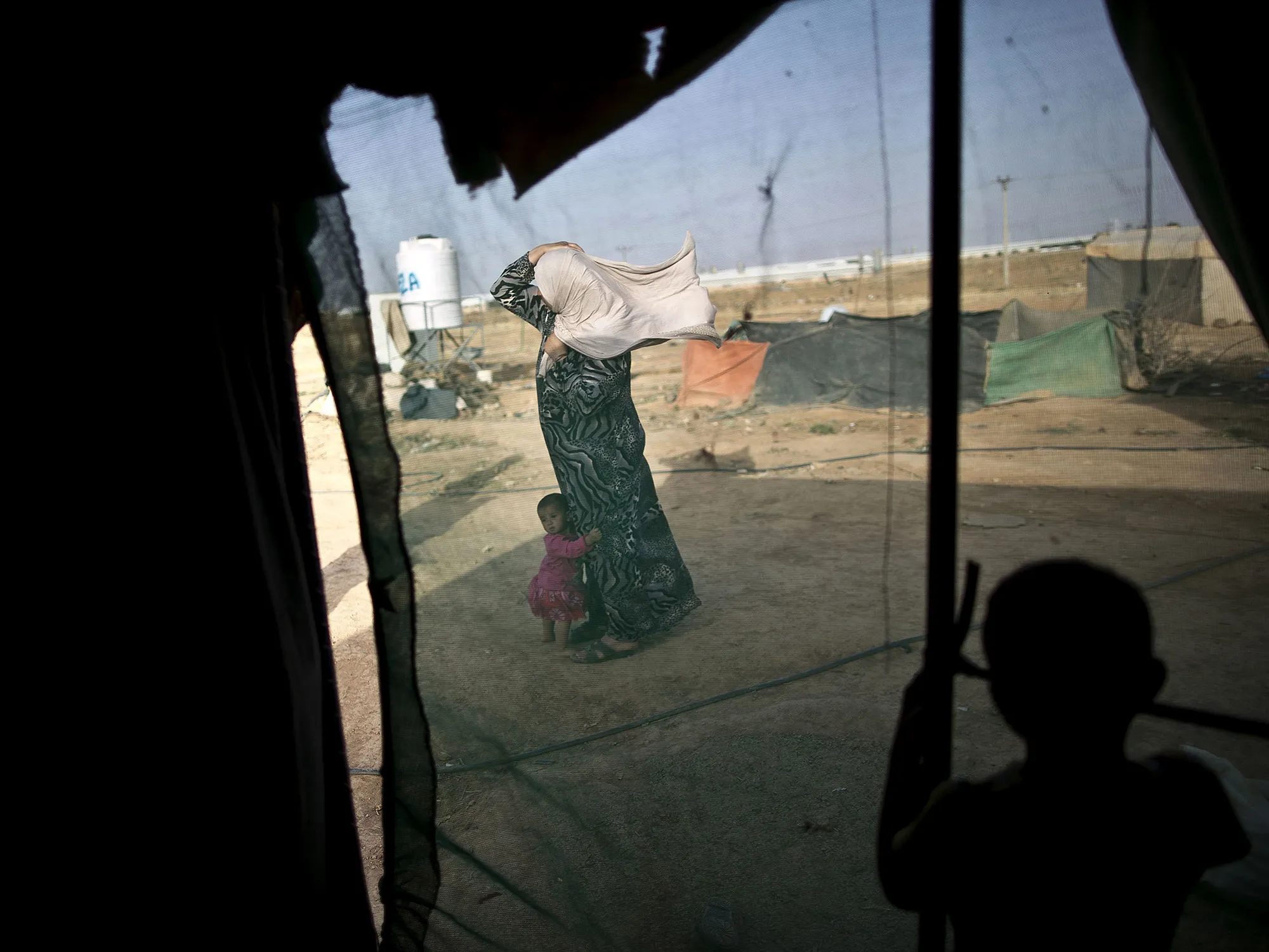 A Syrian refugee and&nbsp;her daughter stand outside their tent at a makeshift settlement near the Syrian border on the outskirts of Mafraq, Jordan, on&nbsp;June 3, 2016.