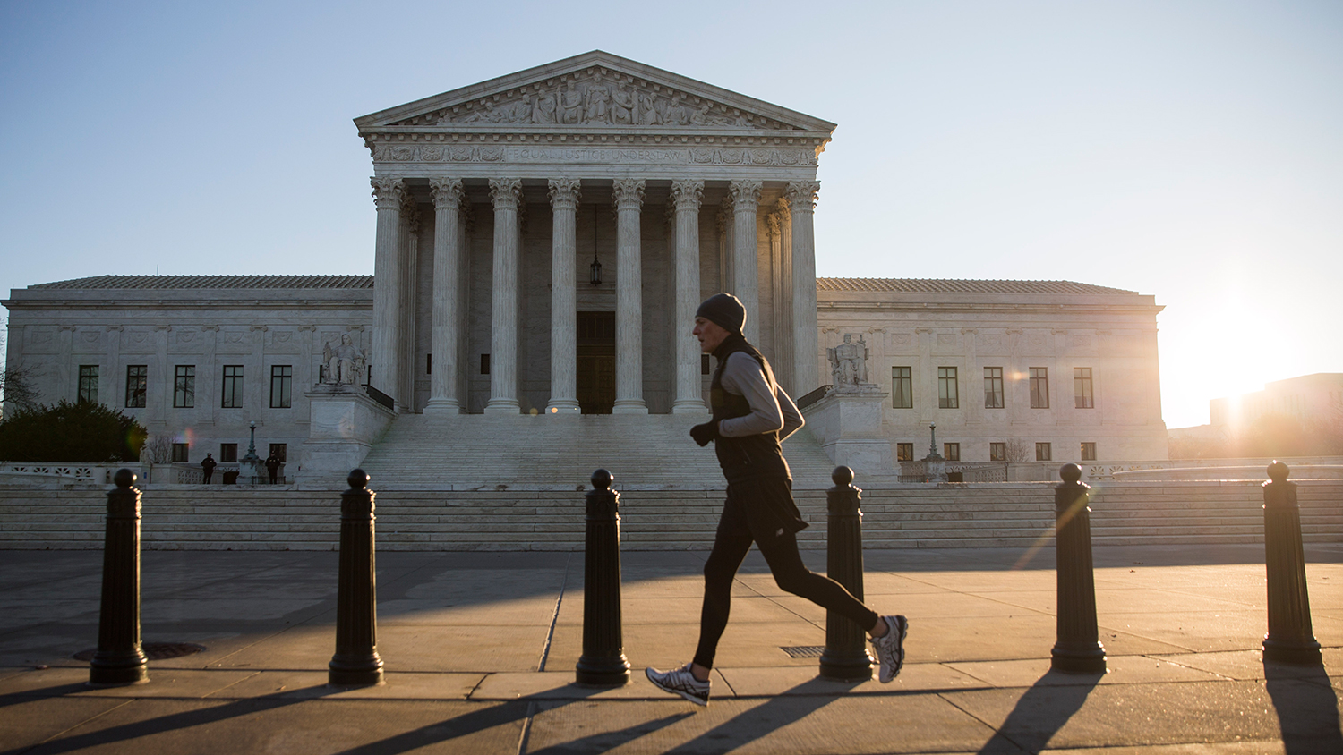 A jogger runs pasts the Supreme Court building on Jan. 16, 2015, in Washington.
