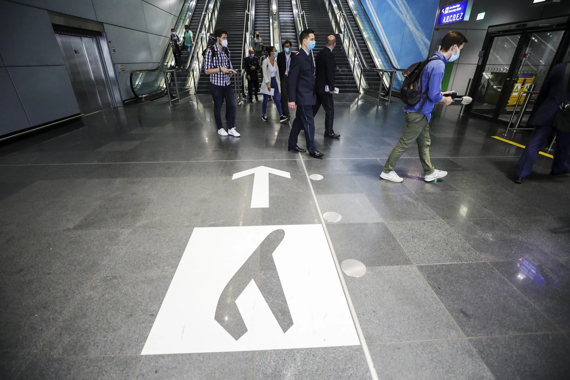 Travelers pass through Frankfurt Airport.