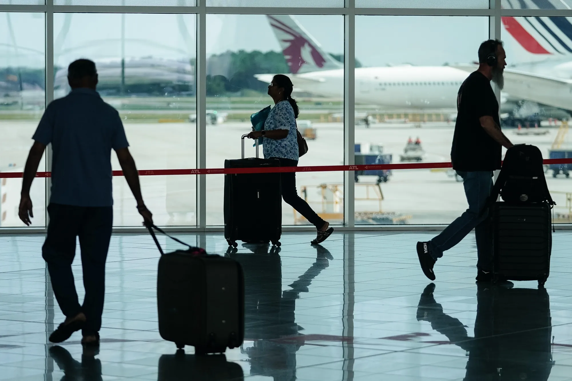 Travelers at Hartsfield-Jackson Atlanta International Airport on July 12.