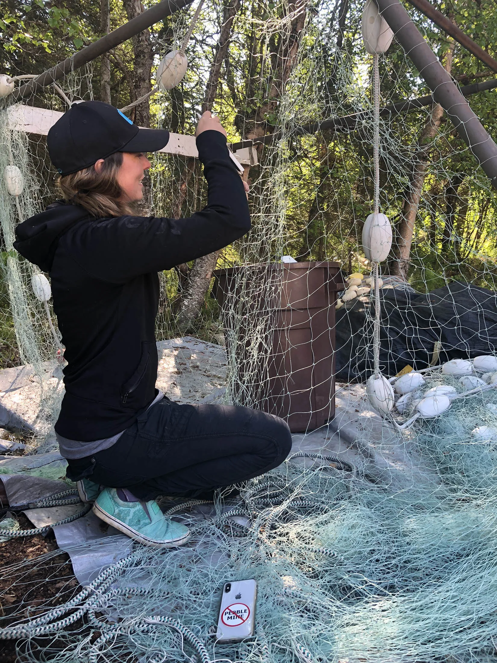 Bristol Bay boat captain Katherine Carscallen mends her fishing nets.