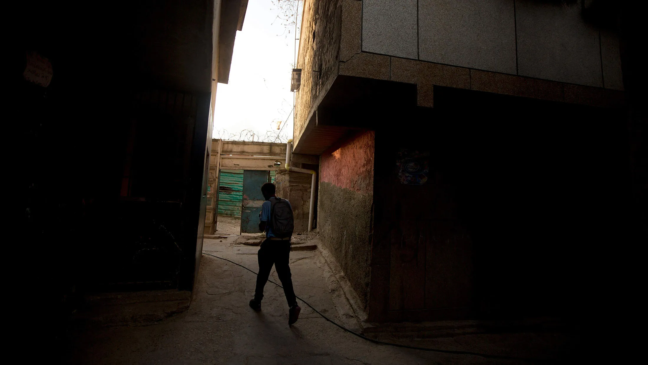 A student quickly walks home in Caracas, Venezuela.
