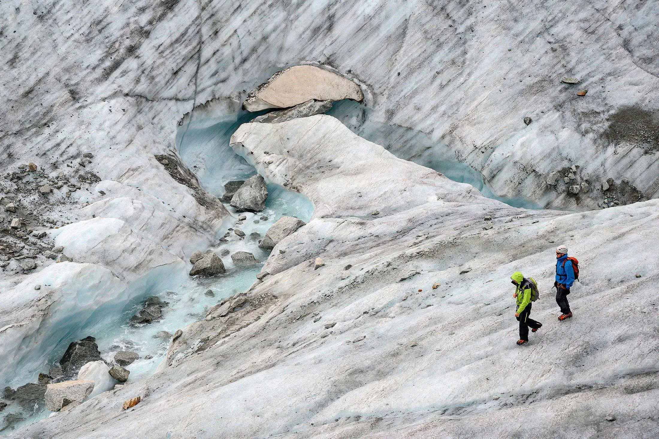 Men walk on the Mer de Glace glacier on June 20, 2019 in Chamonix.