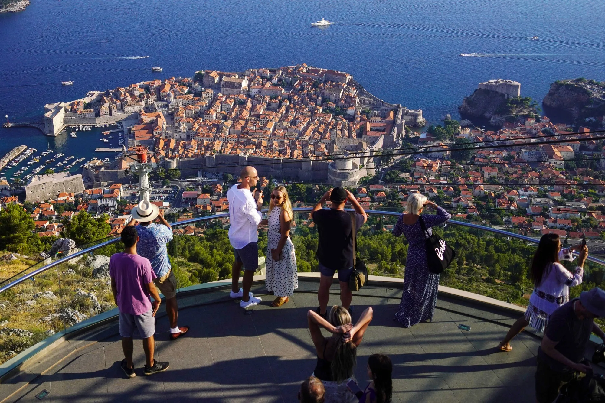 Visitors look out over the the Old Town and the Adriatic Sea in Dubrovnik.