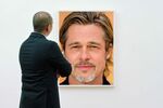 Man in art gallery facing picture, rear view