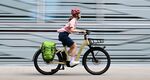 A woman rides an e-bike in Frankfurt, Germany.&nbsp;