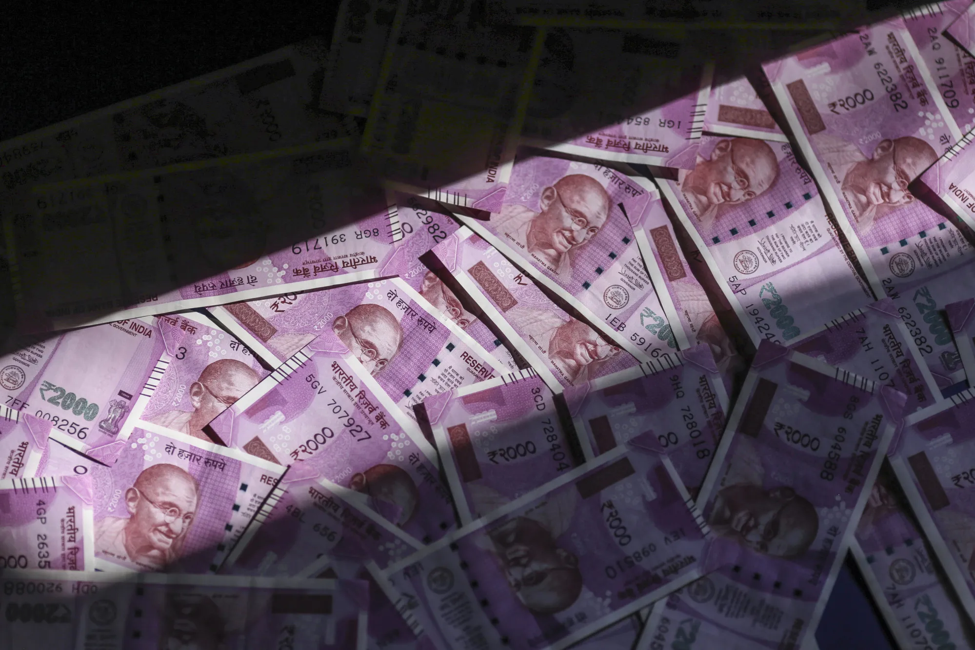 Indian two thousand rupee banknotes are arranged for a photograph in Mumbai, India, on Tuesday, Jan. 30, 2018. Indian Prime Minister Narendra Modi has a tough balancing act in this week's budget: maintaining fiscal prudence or handing out cash to placate rural voters ahead of next year's election.
