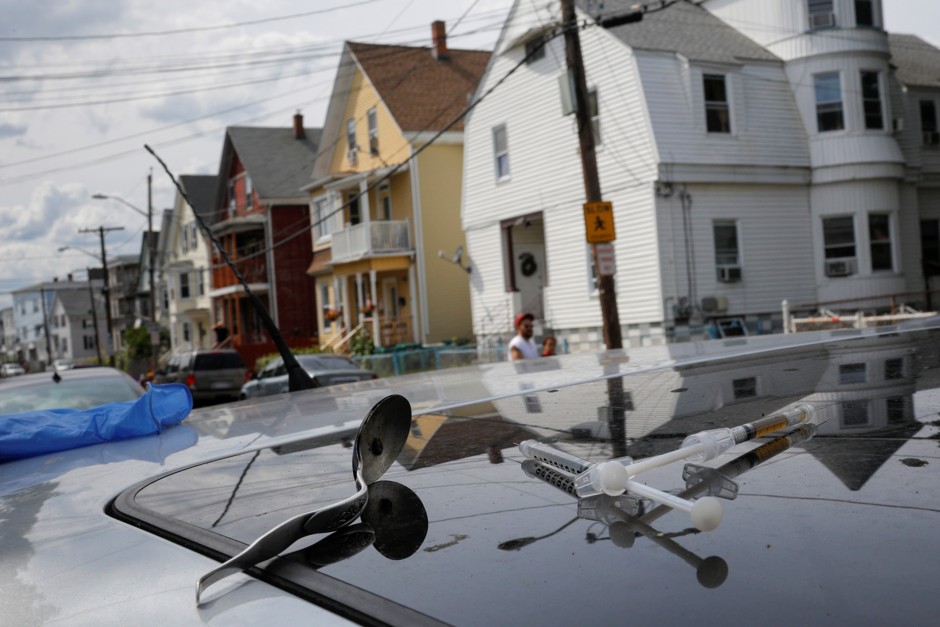 A syringe sits on top of a car in which a man in his 20s overdosed in Lynn, Massachusetts, 2017.