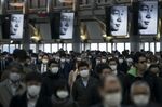 TOKYO, JAPAN - MARCH 26: Commuters wearing face masks make their way to work on March 26, 2020 in Tokyo, Japan. Tokyo Governor Yuriko Koike held a press conference last night to request citizens to refrain from going outside this weekend for nonessential reasons after 41 cases of new coronavirus infections were confirmed yesterday. She warned that Tokyo, one of the largest and most densely populated cities on earth, could face a lockdown if there is a surge in new coronavirus cases. (Photo by Tomohiro Ohsumi/Getty Images)