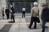 Pedestrians look an electronic stock board outside a securities firm in Tokyo, Japan, on Tuesday, May 7, 2019. Trading resumed Tuesday after a 10-day Golden Week holiday with a slew of news for investors to process.