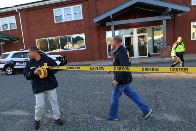 Federal agents investigate the offices of New England Compounding Center in Framingham, Mass., Oct. 16, 2012. The company's steroid medication has been linked to a deadly meningitis outbreak
