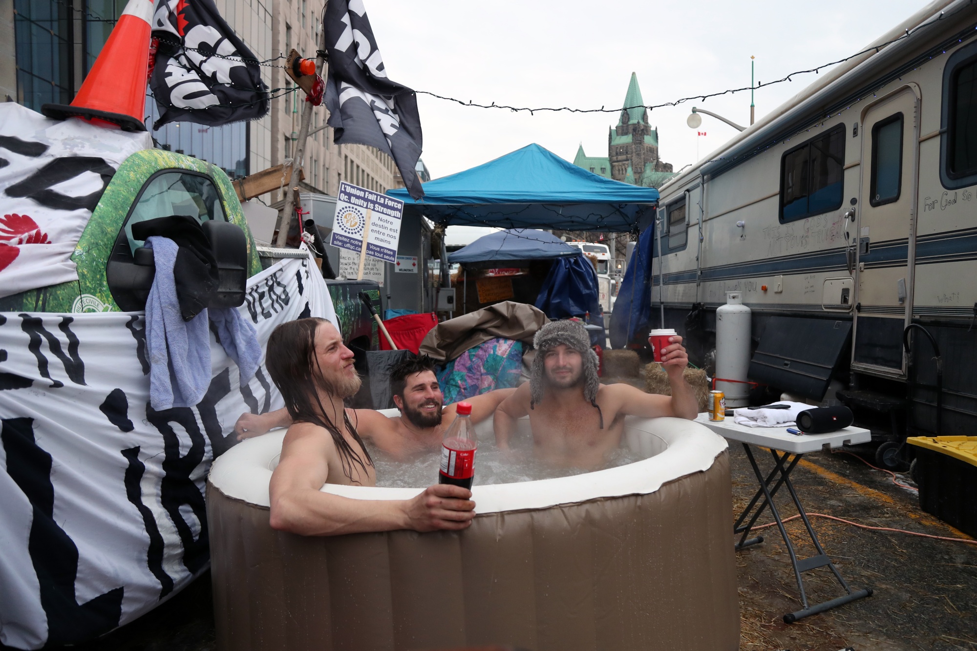 Protesters sit in a hot tub along the main avenue in front of the parliament buildings in Ottawa on Feb. 16.