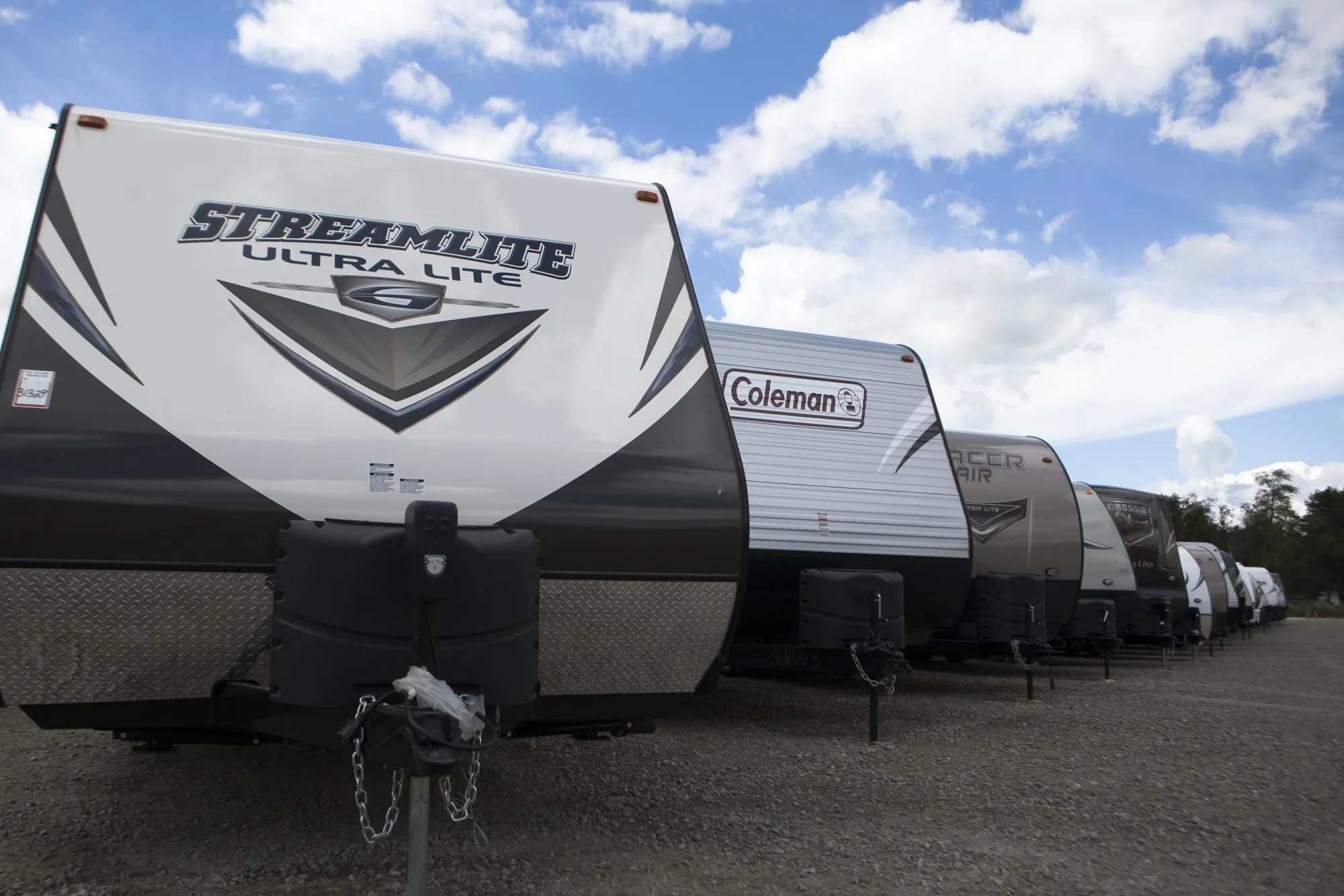 Recreational vehicles sit in a lot waiting for delivery at Horizon Transport in Wakarusa, Ind. on July 15, 2014. RV delivery is a growing trend that allows travelers to enjoy all of the conveniences of staying in an RV without actually having to drive it. Several companies offer delivery services for customers who rent, which can not only be more convenient, but also more affordable. (James Buck/The Elkhart Truth via AP)