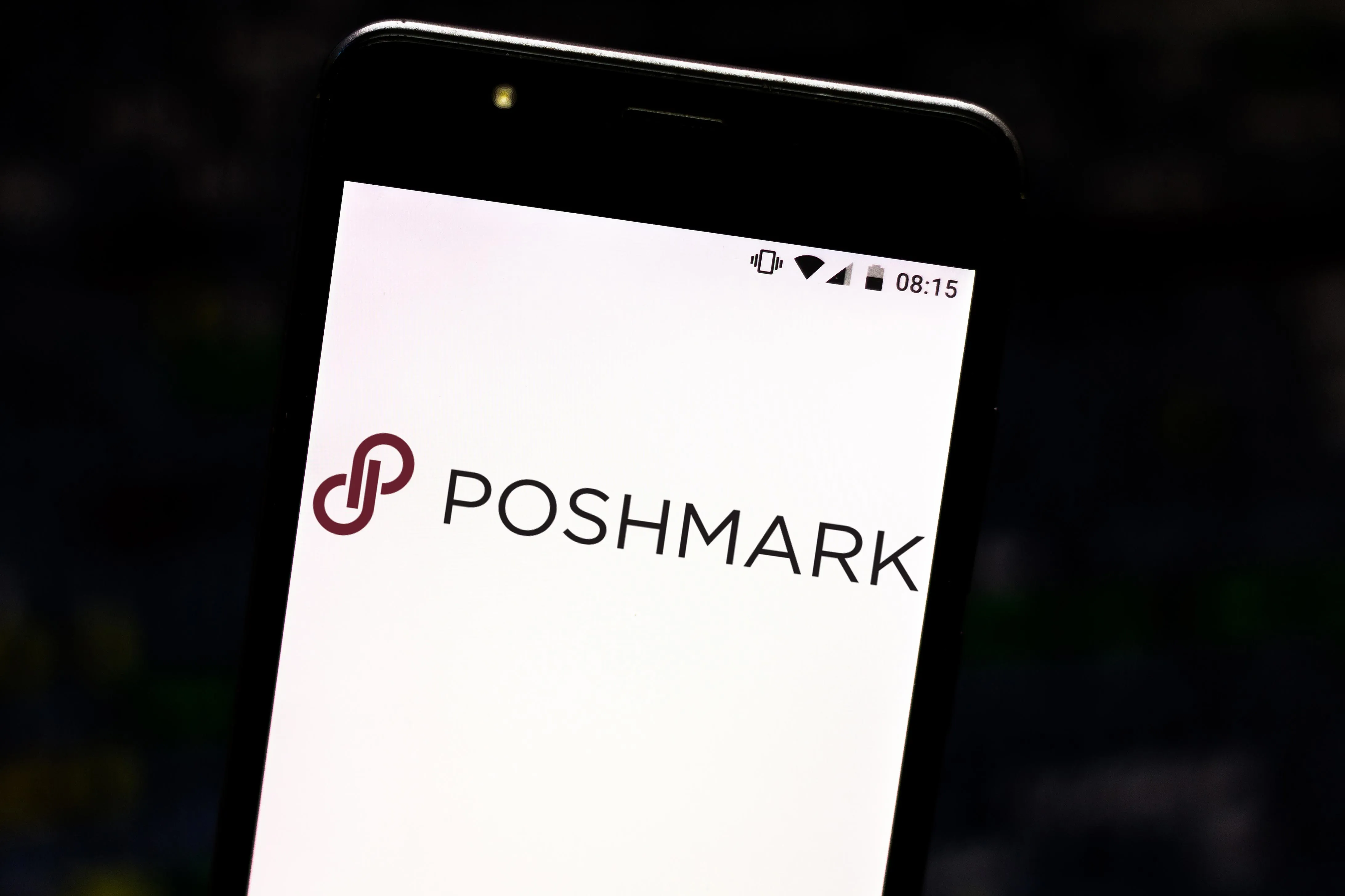 In this photo illustration a Poshmark logo seen displayed on