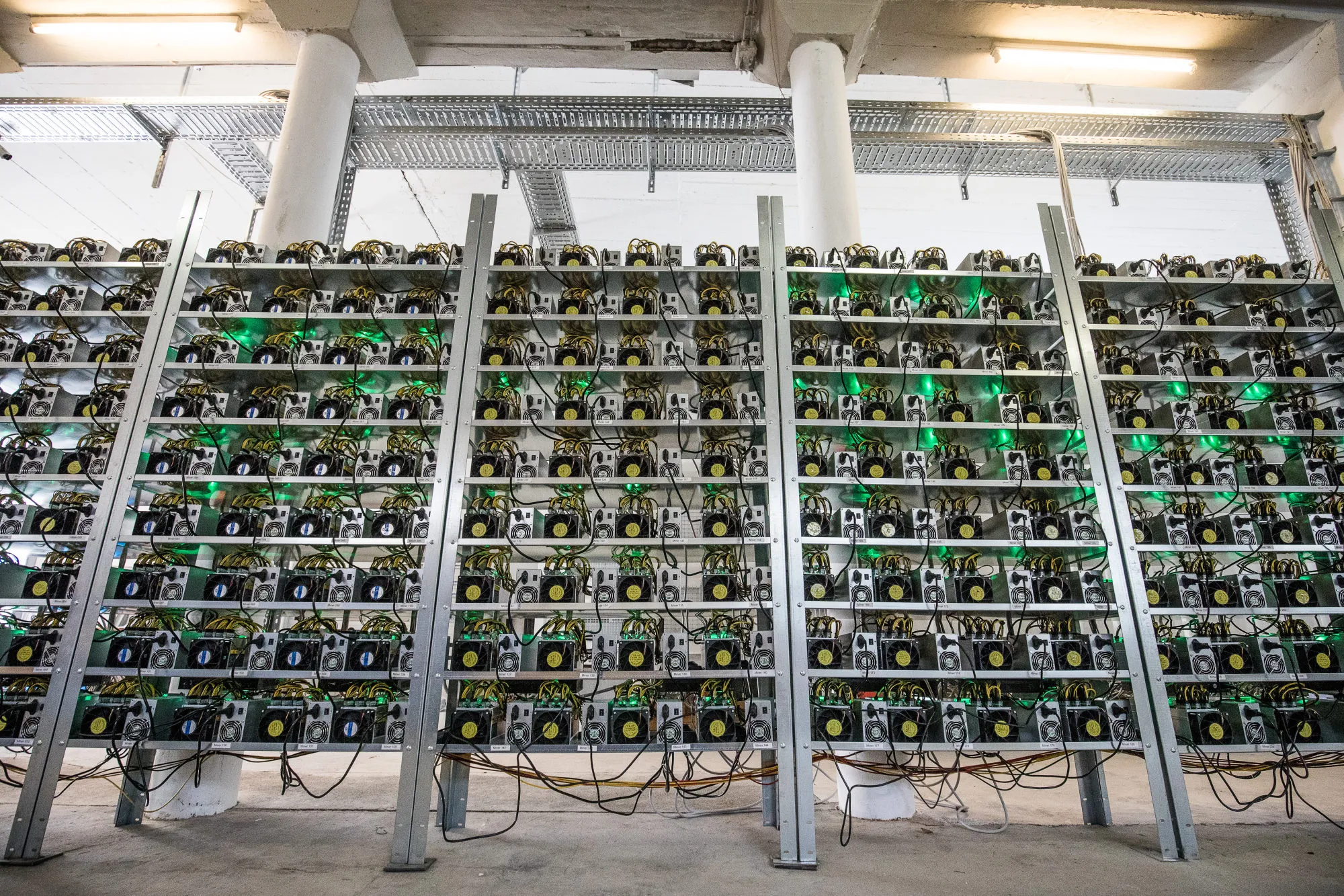 Cryptocurrency mining rigs composed of Antminer S9 ASIC machines operate on racks at the HydroMiner GmbH cryptocurrency mining facility near Waidhofen an der Ybbs, Austria.