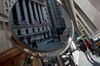 The New York Stock Exchange (NYSE) is reflected in a street vendor's mirror in New York, U.S., on Monday, March 5, 2018. U.S. stocks turned higher and Treasuries erased gains as investors speculated that President Donald Trump's tough tariff talk won't translate into the most severe protectionist policies.