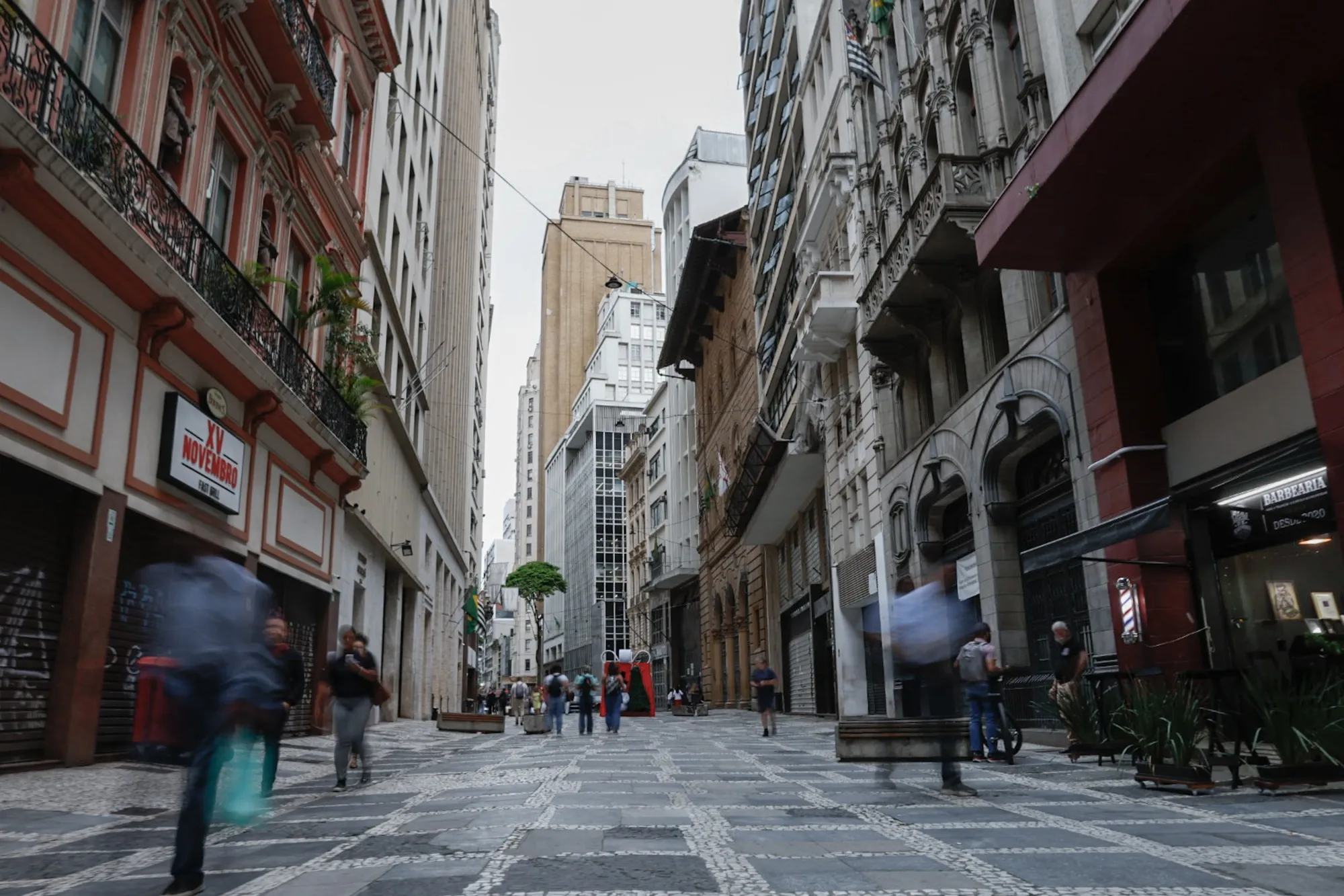 Pedestrians walk through the financial district in Sao Paulo, Brazil.