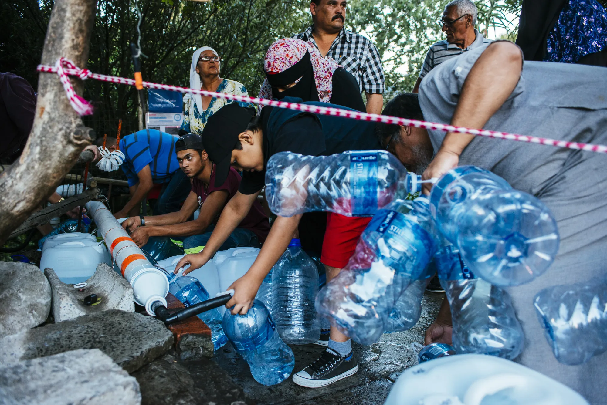 Residents collect water from a pipe at the Newlands natural water spring in Cape Town in 2018.