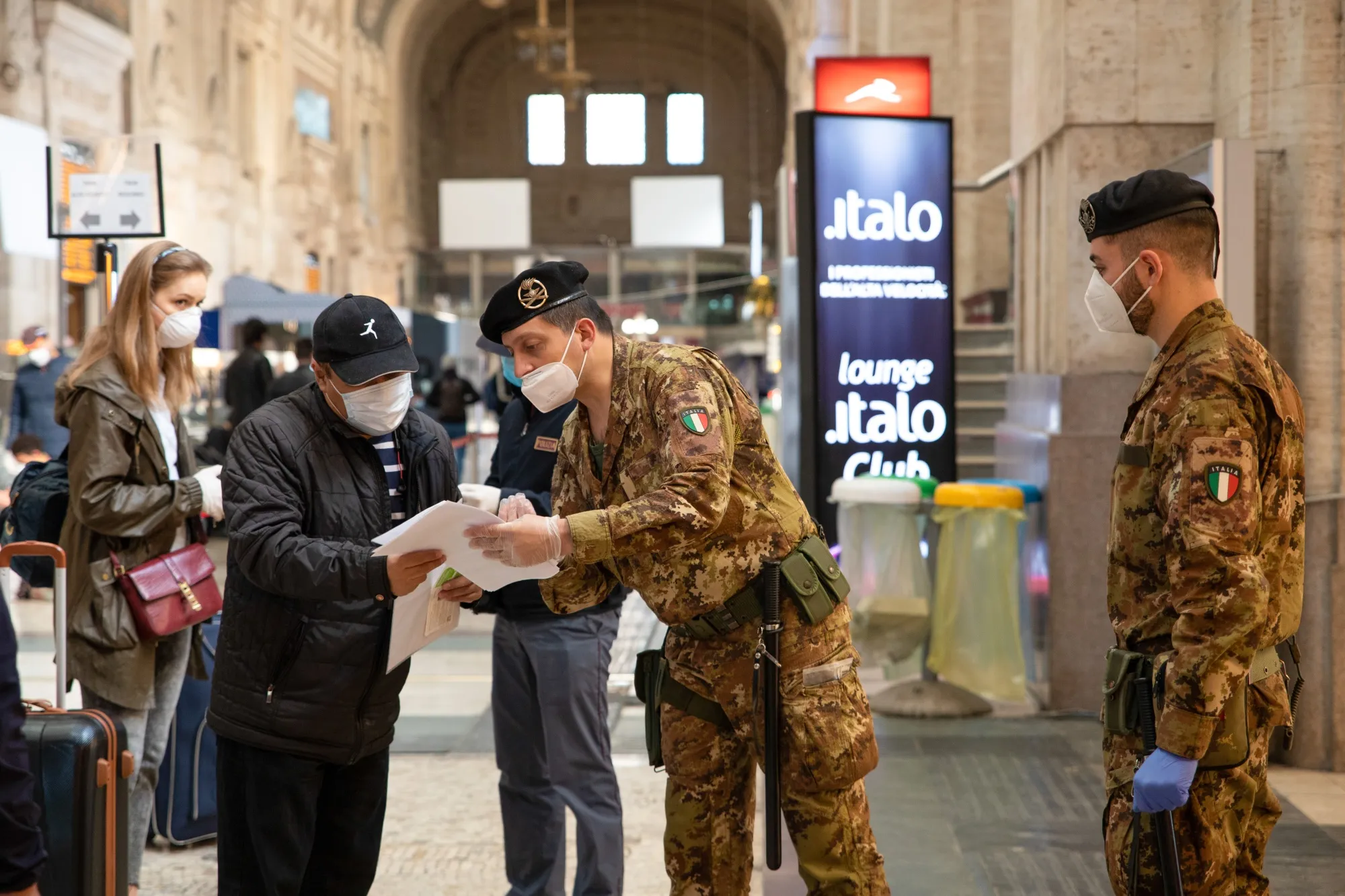 Military personnel check commuter documents at Milano Centrale station, on May 4.