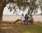 Tawana Promprakai and Delphine Gillard on the land that once belonged to their family on St. Helena Island, S.C.&nbsp;