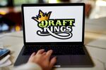 The logo for DraftKings is displayed on a laptop computer in an arranged photograph taken in Little Falls, New Jersey, U.S., on Wednesday, Oct. 7, 2020. The pricing of a DraftKings Inc. share sale combined with a fresh wave of Covid-19 infections across the National Football League sent shares of the online gaming company tumbling this week.
