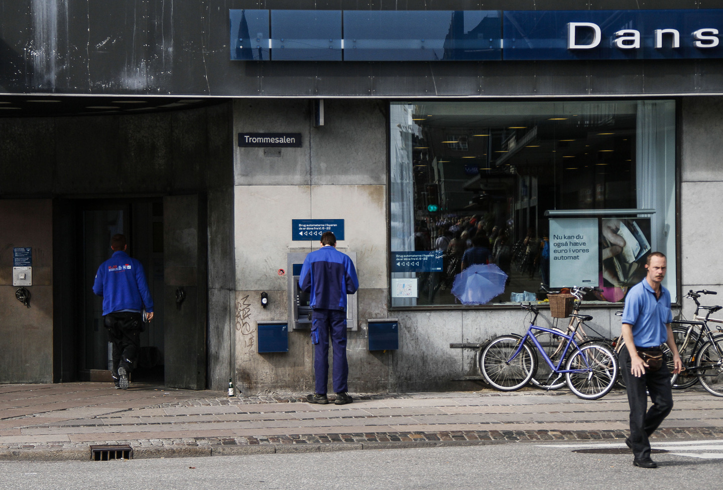 A customer uses an ATM&nbsp;outside a Danske Bank A/S branch in Copenhagen, Denmark.