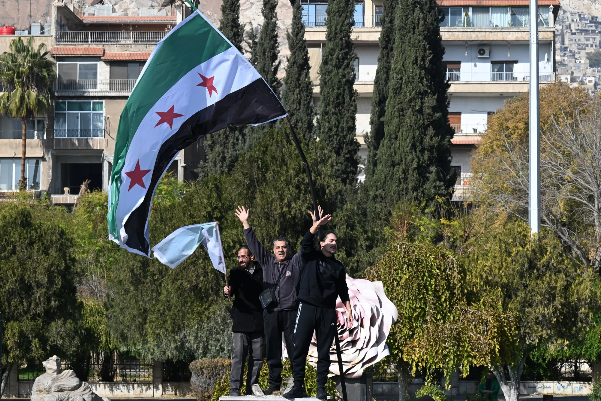 People celebrate at Umayyad Square in Damascus, Syria, on Dec. 9.