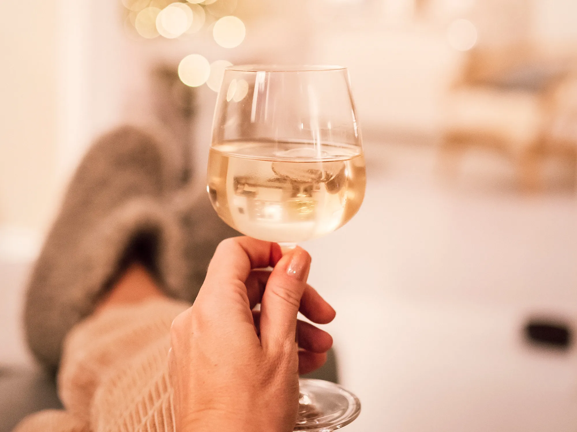 Drinking wine in sofa infront of christmas tree