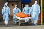 Medical workers&nbsp;move the body of a deceased patient to an overflow morgue outside the Wyckoff Heights Medical Center in Brooklyn on&nbsp;April 2.&nbsp;