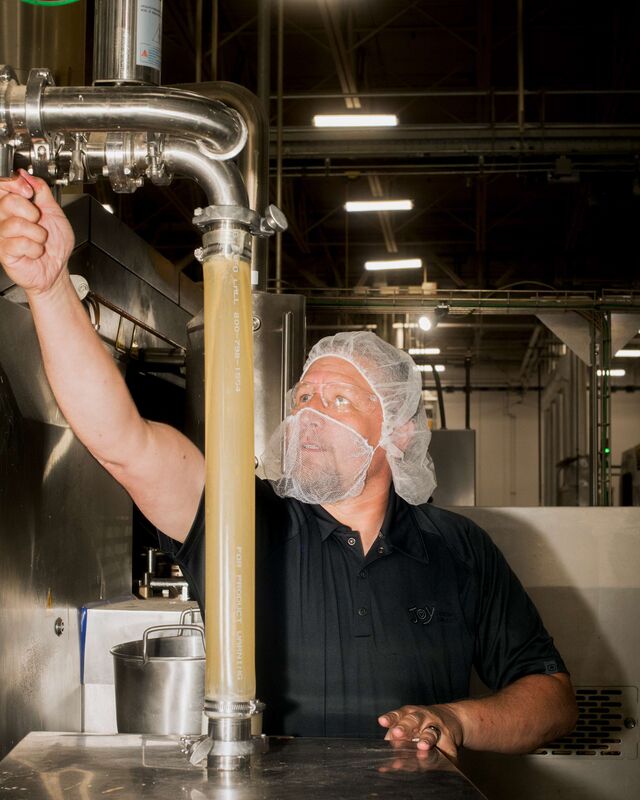 Assistant plant manager Jason Loeblein adjusts a tube that receives cooled batter.