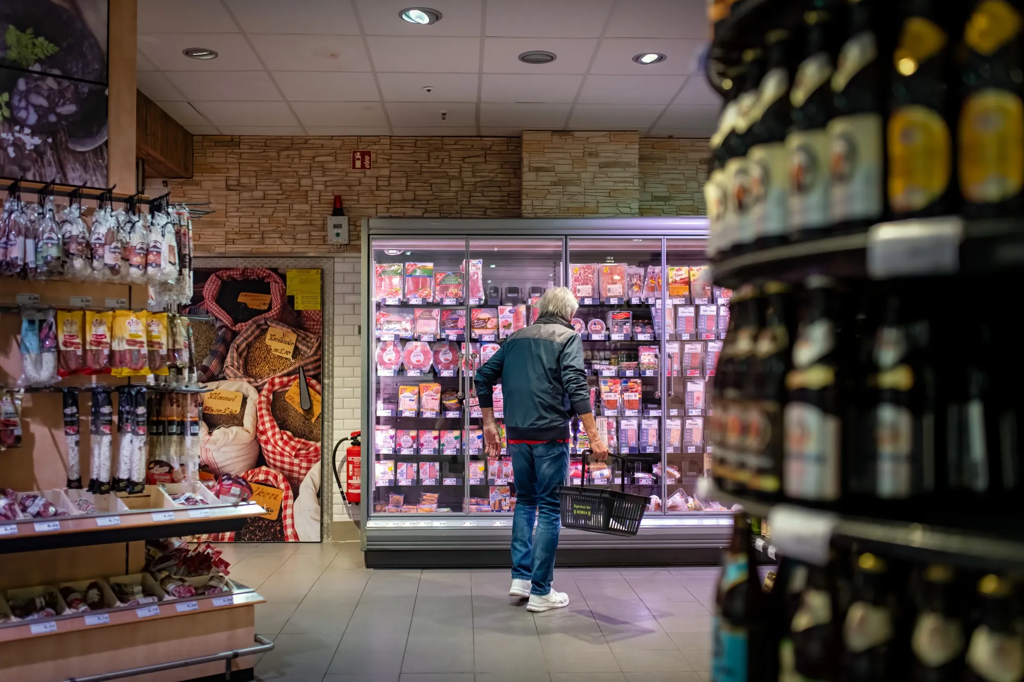 A shopper browses cold cuts at a supermarket in Hamburg, Germany.