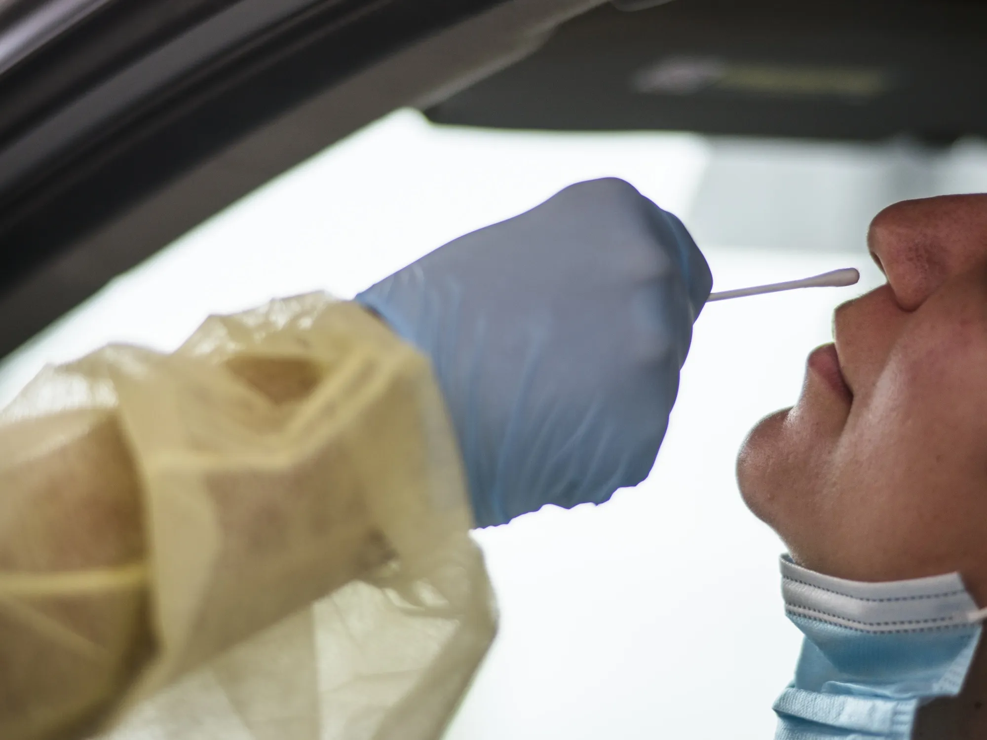 A healthcare worker administers a Covid-19 test in Austin, Texas.