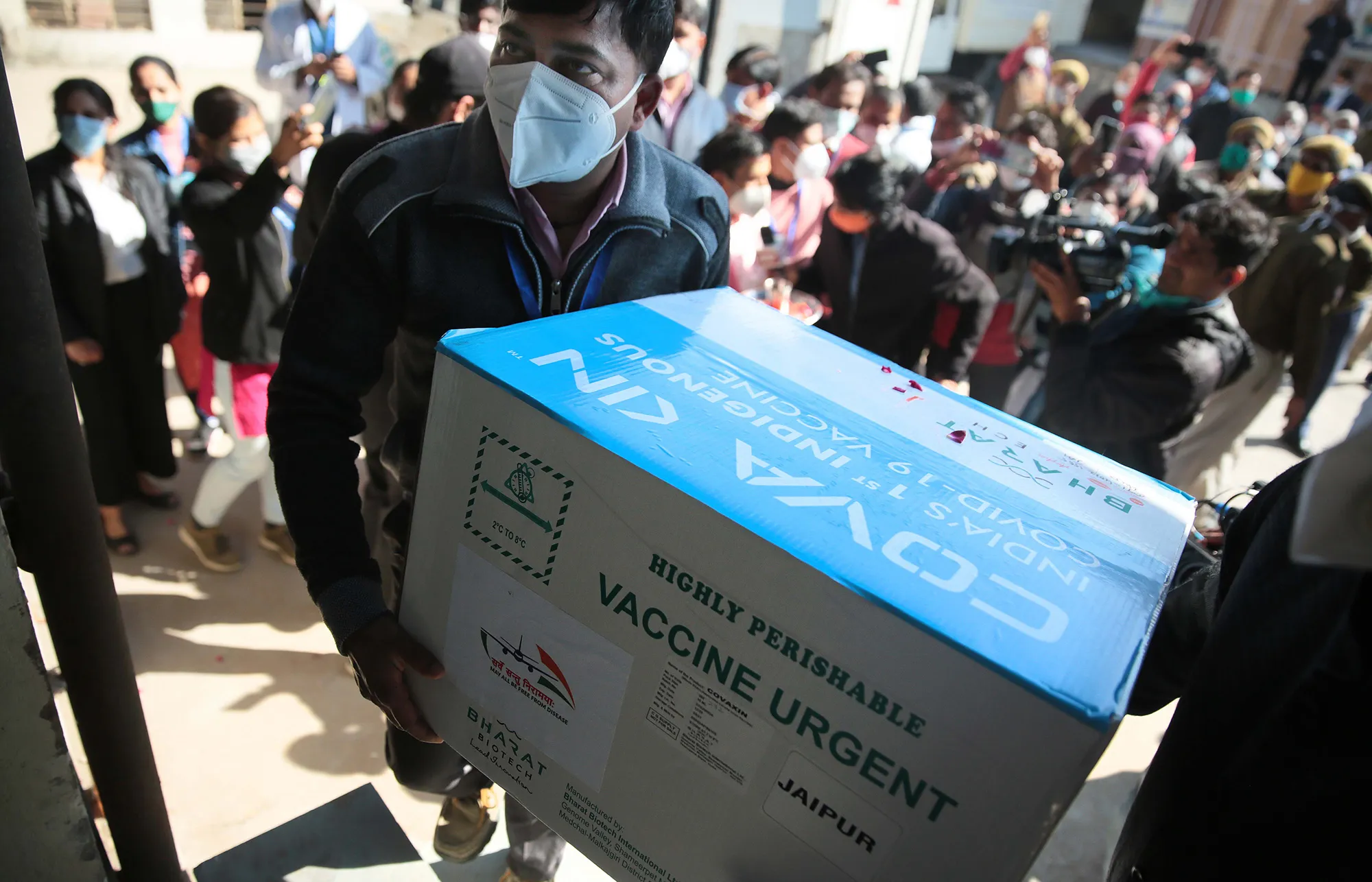 A health worker carries a box of&nbsp;vaccines during delivery in Jaipur, India on Jan. 13.
