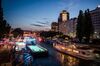 Lights illuminate pleasure boats on the Danube canal in the Donaukanal district of Vienna, Austria, on Tuesday, July 23, 2013. Kommunalkredit Austria AG, the Austrian nationalized municipal lender, will have to wind down its loan book and close when that's complete after attempts to sell the bank failed, the European Commission said.
