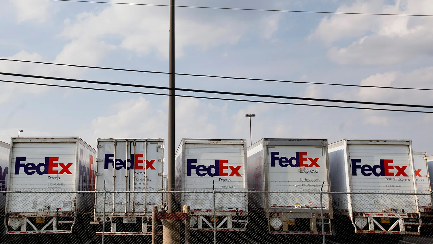 FedEx Corp. trucks sit lined up in a parking lot of the company's ship center near the Memphis International Airport in Memphis, Tennessee, U.S., on Saturday, Aug. 16, 2014.

