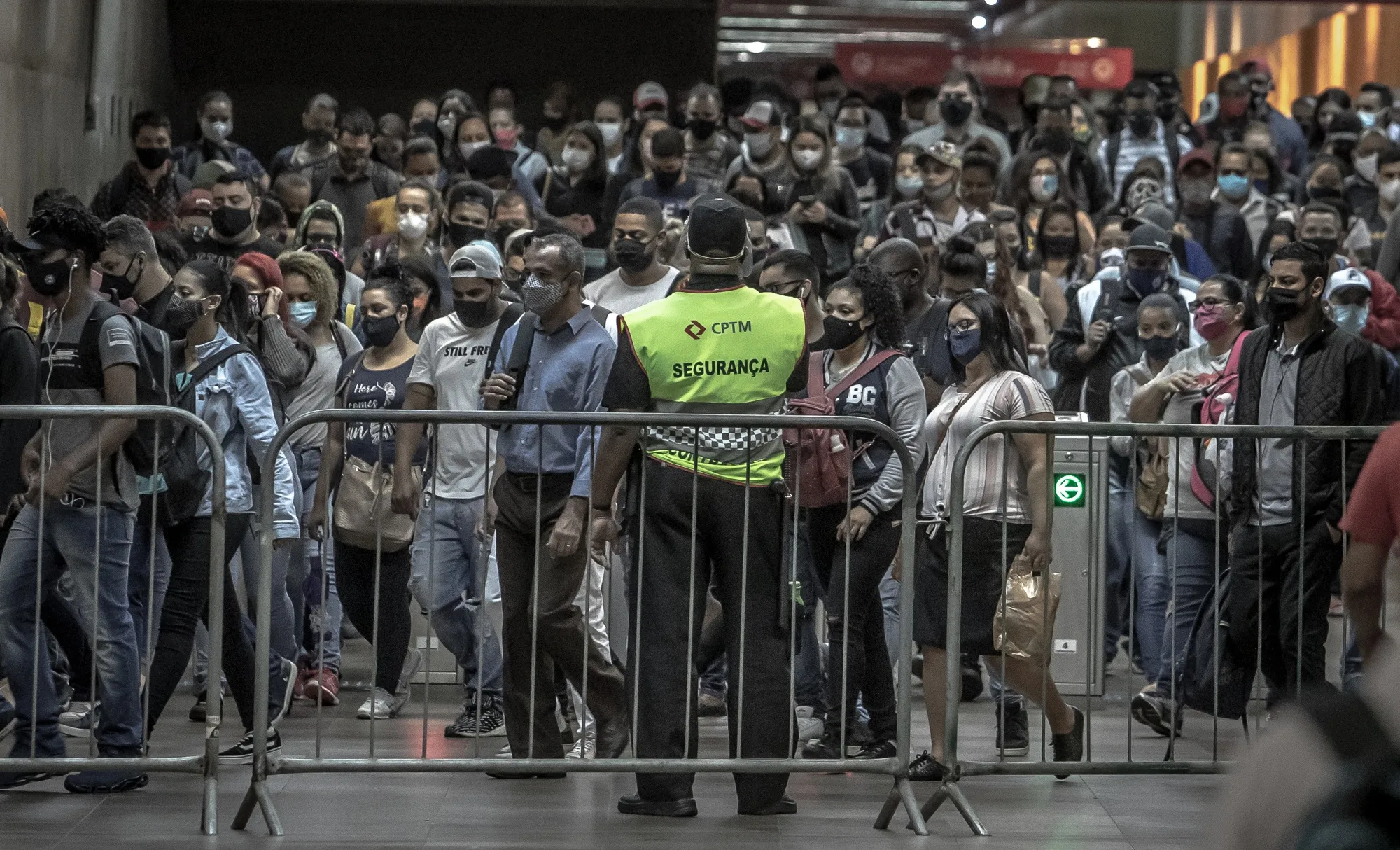 Commuters wear protective masks inside the Luz train station in Sao Paulo, Brazil, on&nbsp;Oct. 8.