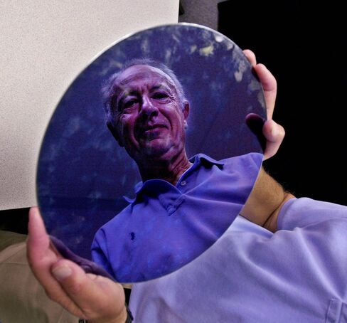 Andy Grove holds an Intel 300mm wafer in 2001.
