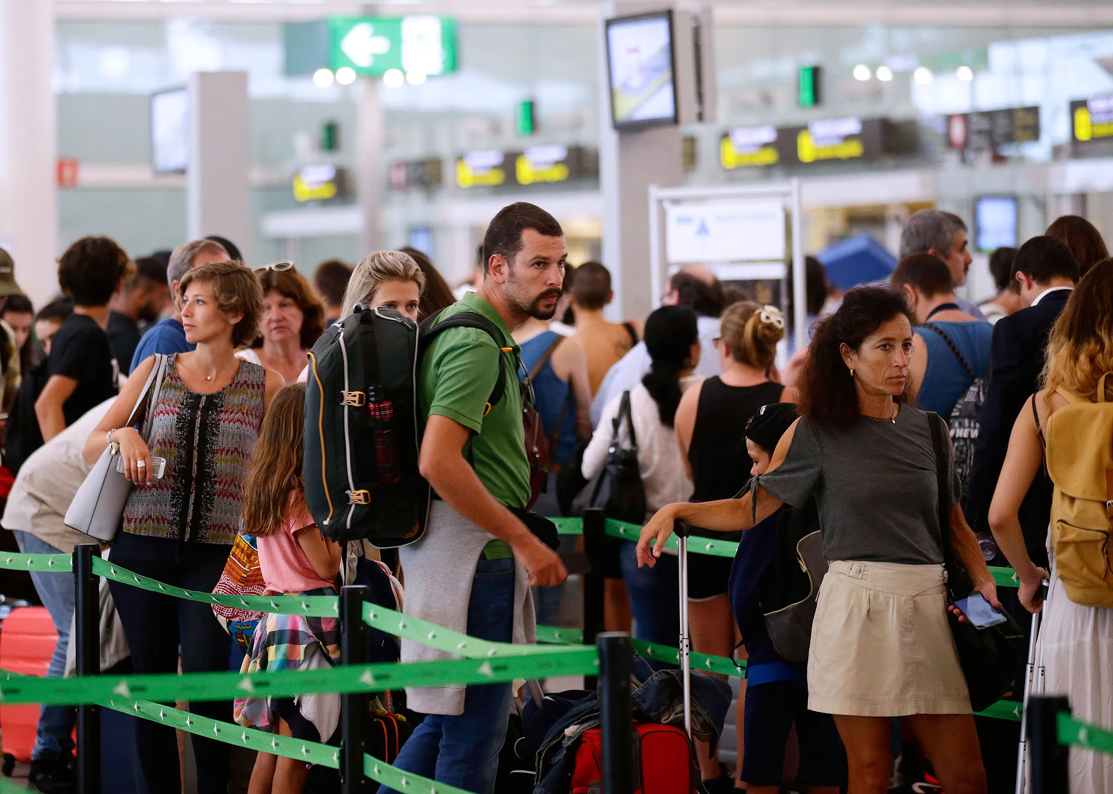 Passenger wait to pass the security control at the Barcelona airport in Prat Llobregat, Spain.
