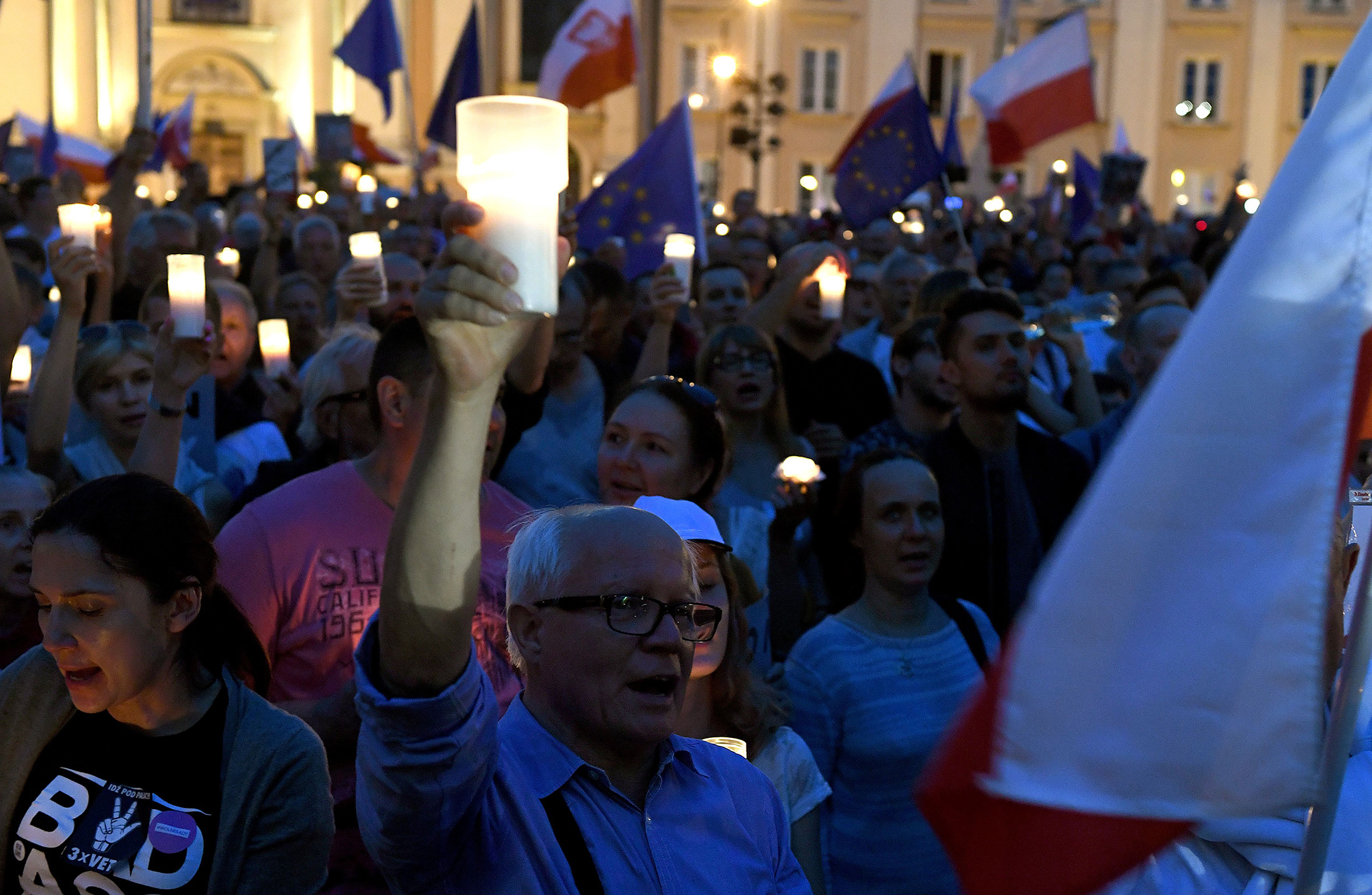 A man holds a candle as protesters take part in a demonstration in front of the Polish Supreme Court on July 23, 2017, in Warsaw to protest against the new bill changing the judiciary system.&nbsp;