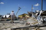 A resident surveys damage following Hurricane Ian in Matlacha Isles, Florida, on Oct. 1.