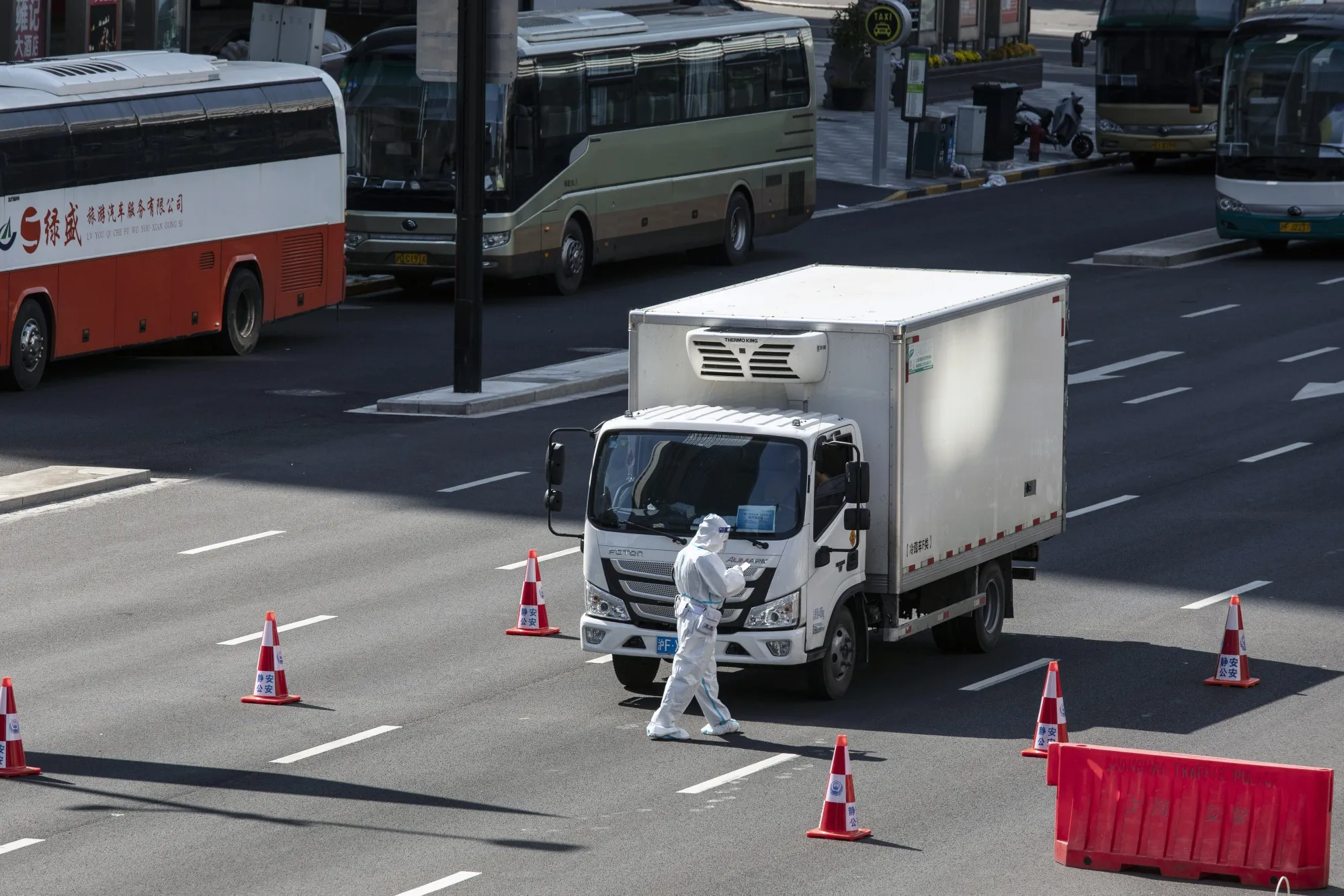 A police officer mans a checkpoint on a near-empty road during a lockdown in Shanghai.
